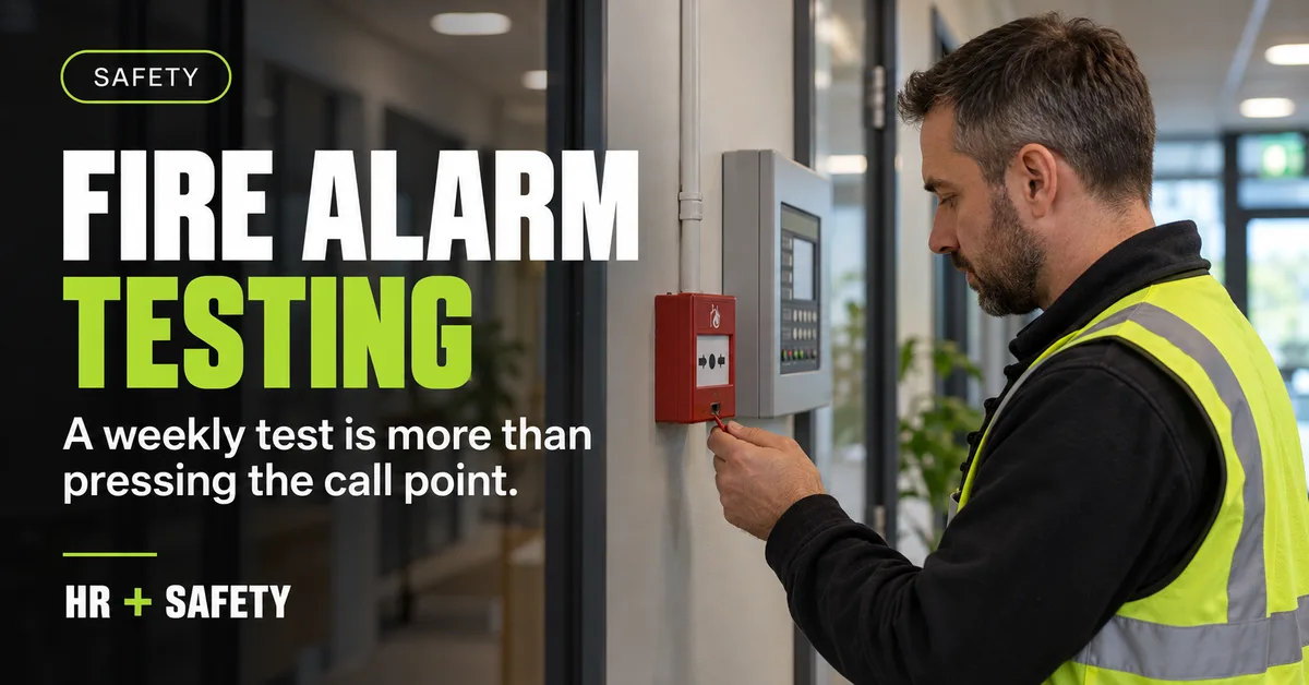 Facilities manager testing a red workplace fire alarm call point