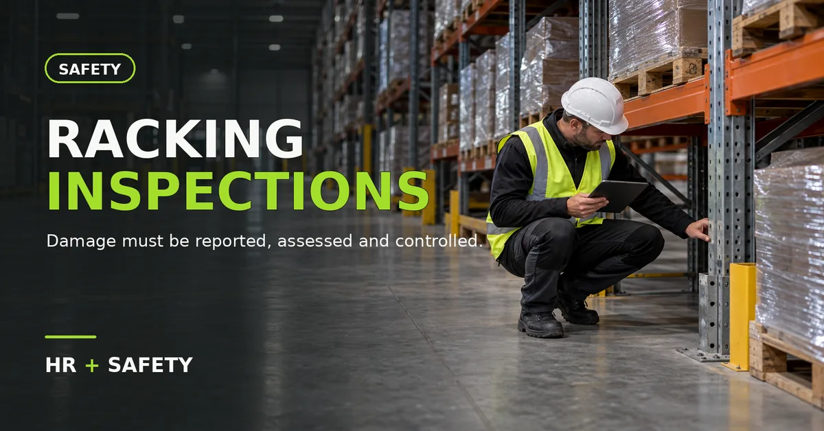 Safety inspector checking the lower upright of pallet racking in a warehouse